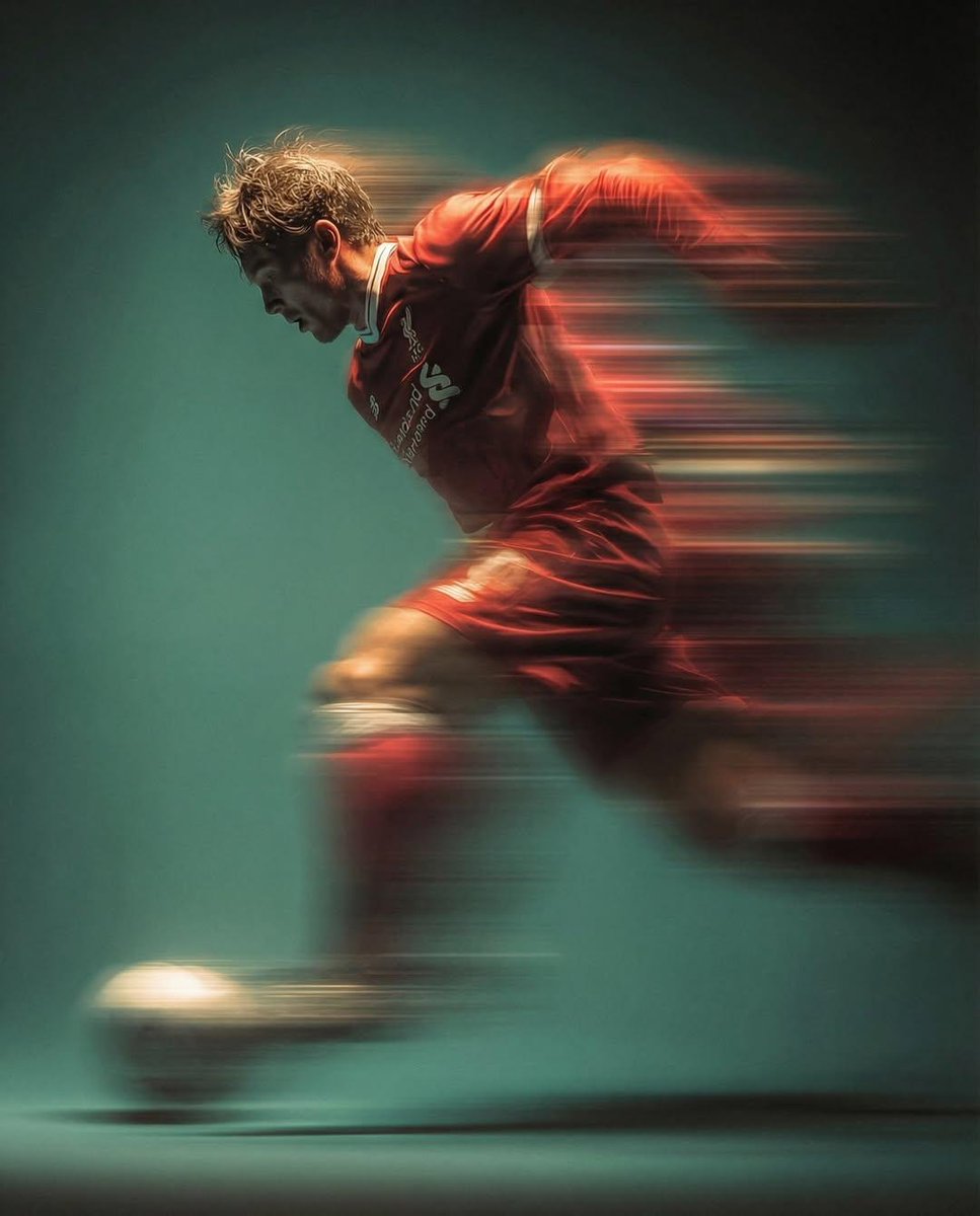 Panning shot of a mysterious soccer player in red proffesiona...